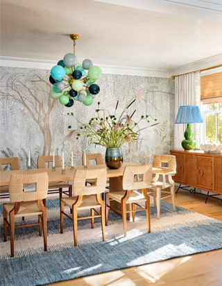 In the dining room of this revitalized historic Southampton home which was designed by Ariel Okin Interiors a mural from...