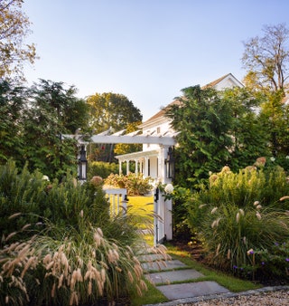 A view through the entrance gate toward the historic 19thcentury Southampton home which was completely refurbished and...