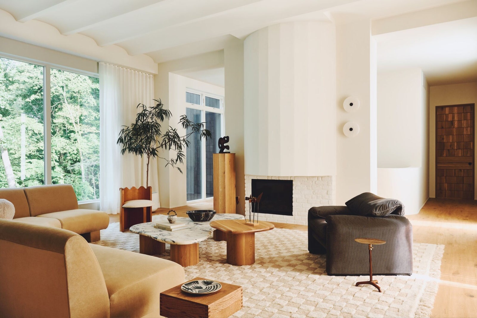 The living room features Sherman Samuels Irregular Checkerboard Handknotted Wool Rug Ripple accent chair and SSS...