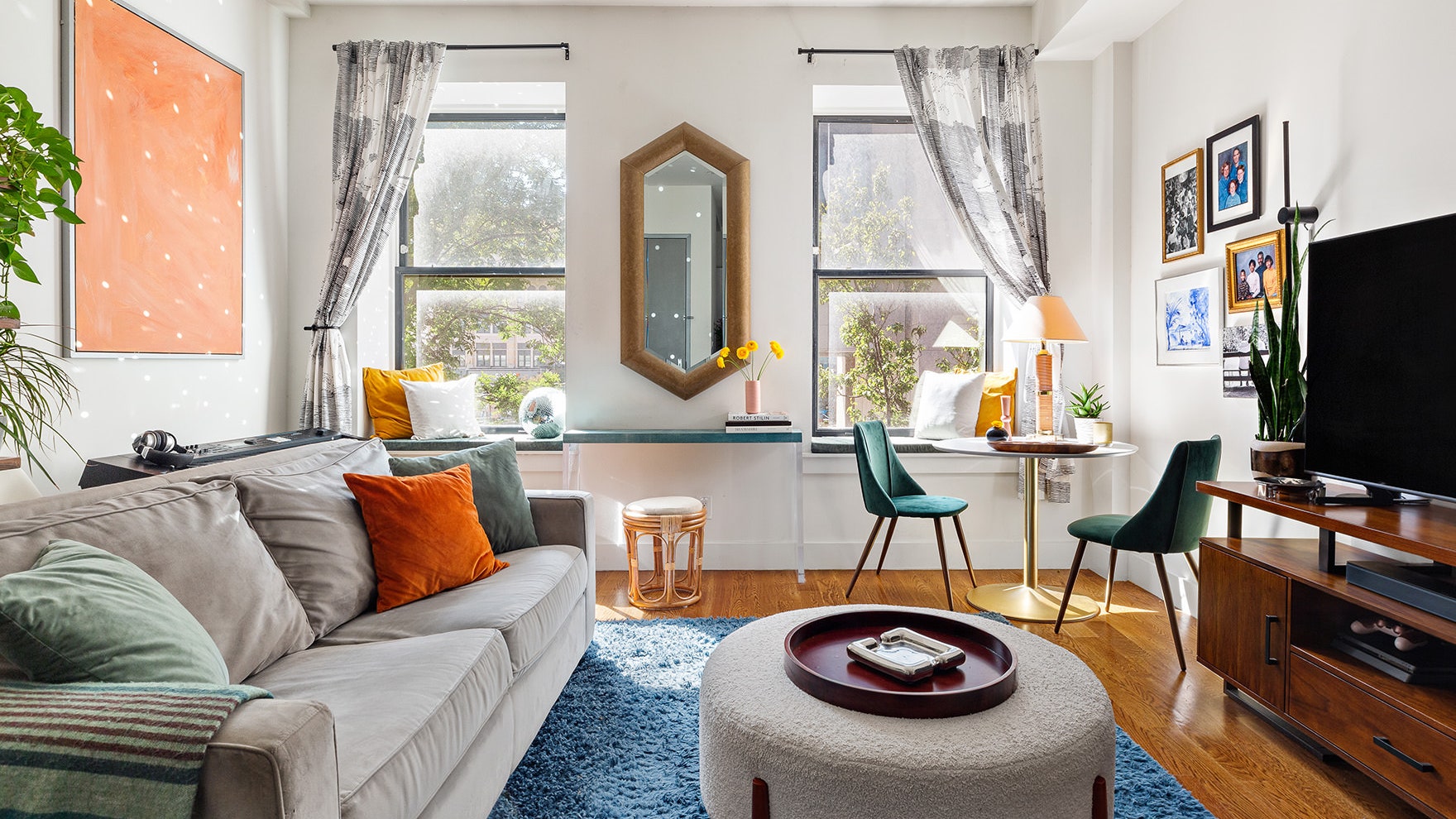 The hexagonal ostrich skin mirror which sits between the two windows is Brads favorite item in the living room.