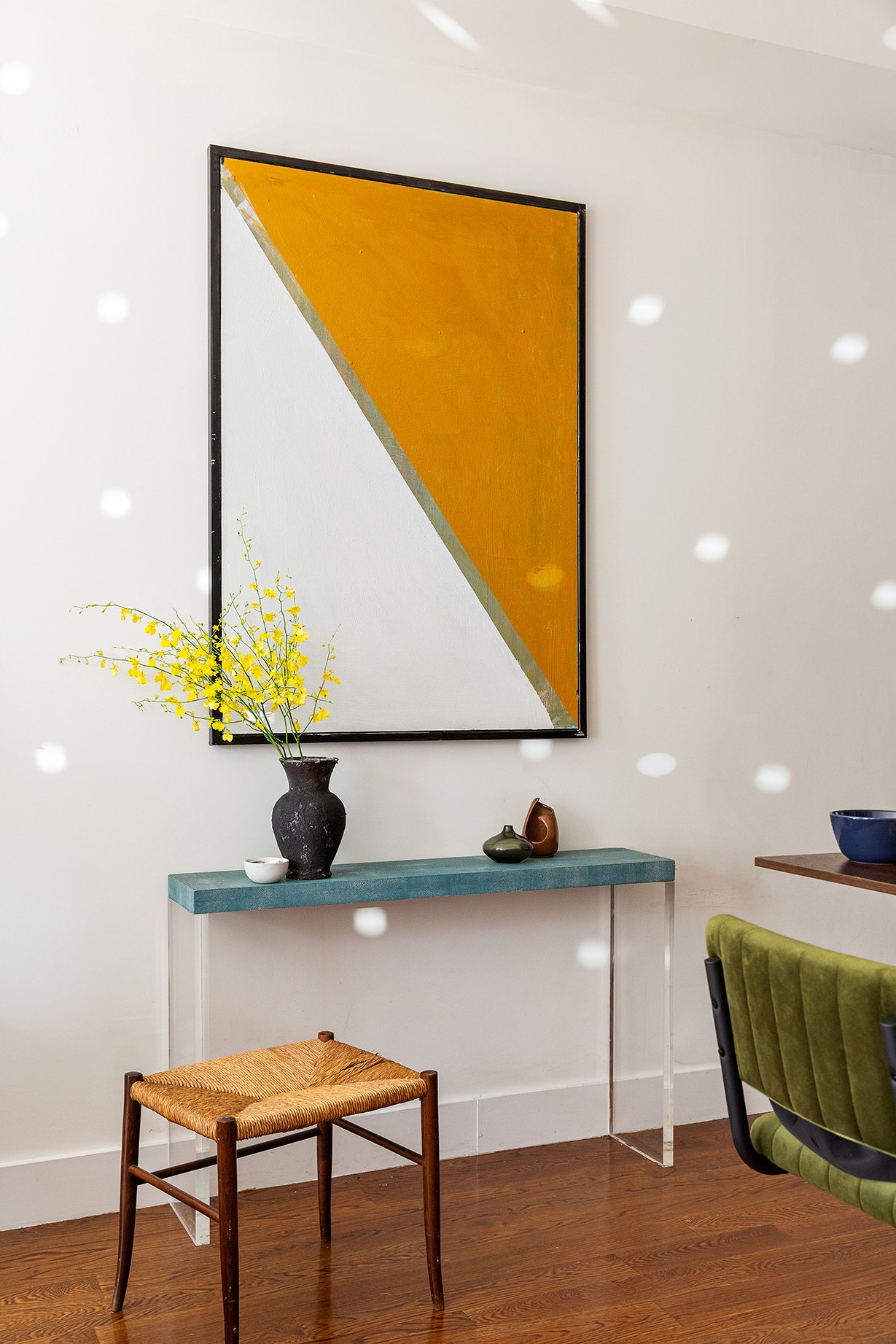 Brad created much of the apartments art himself including the painting that hangs above the vintage shagreen console.