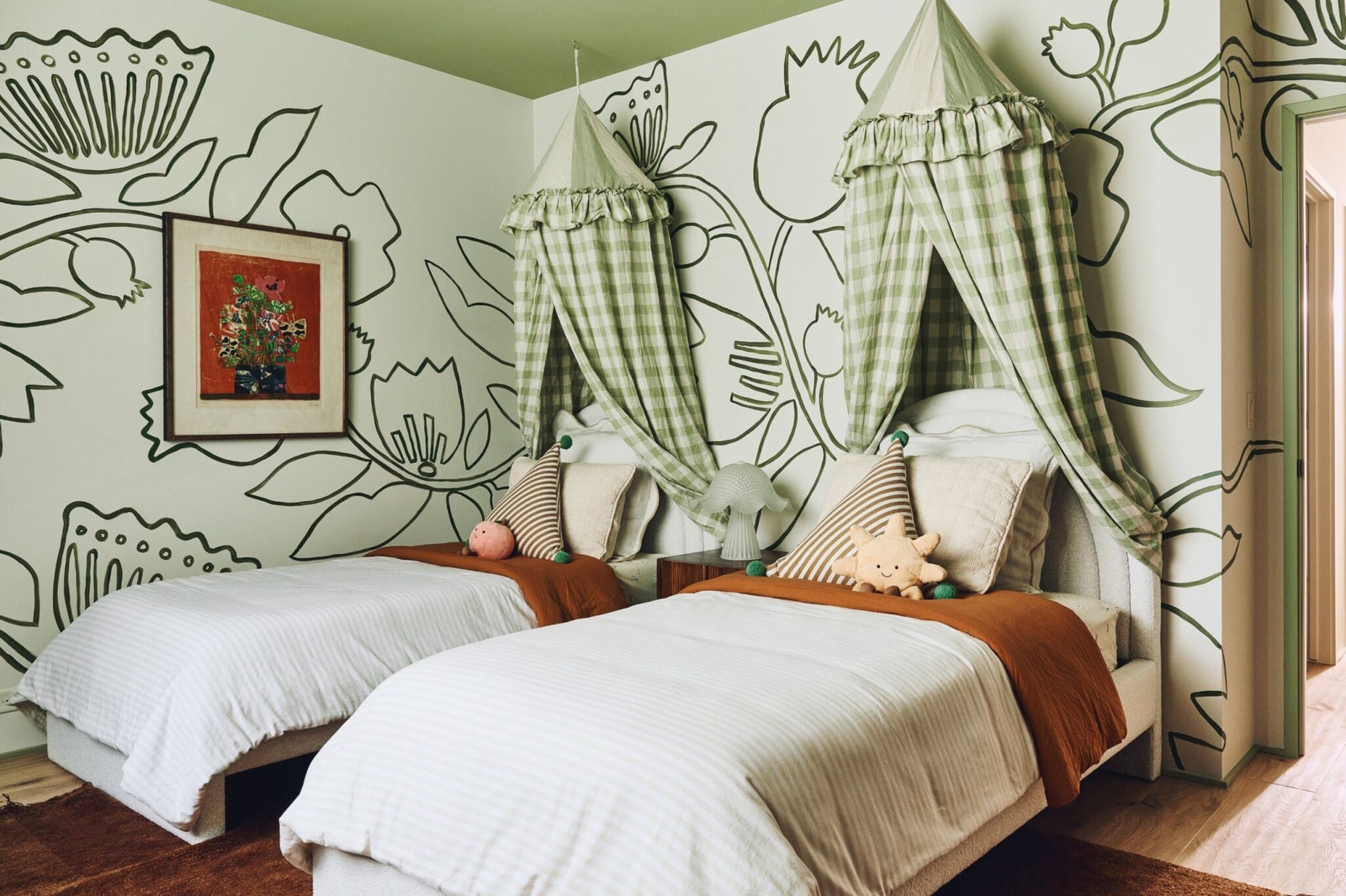 Sherman Samuel handpainted an oversized floral motif on the walls of the kids room.