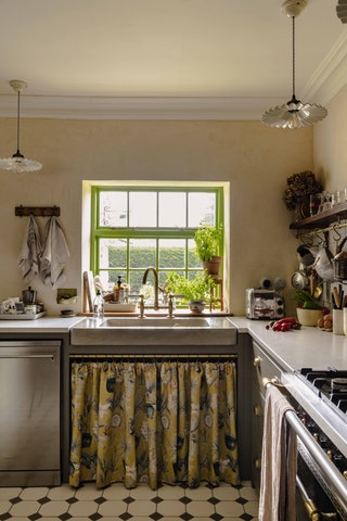 Instead of a cabinet door add a decorative skirt under the sink. Photographer Carole Poirot executed this expertly in...