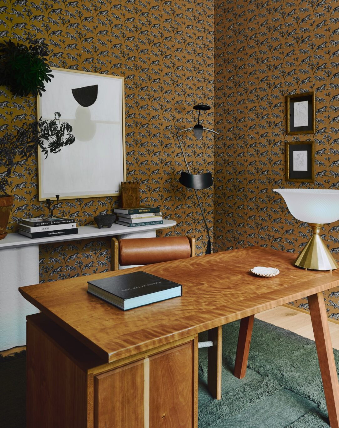 An office includes Tiger Grasscloth wallpaper from Sherman Samuels own line for Lulu and Georgia as well as the Tatia...