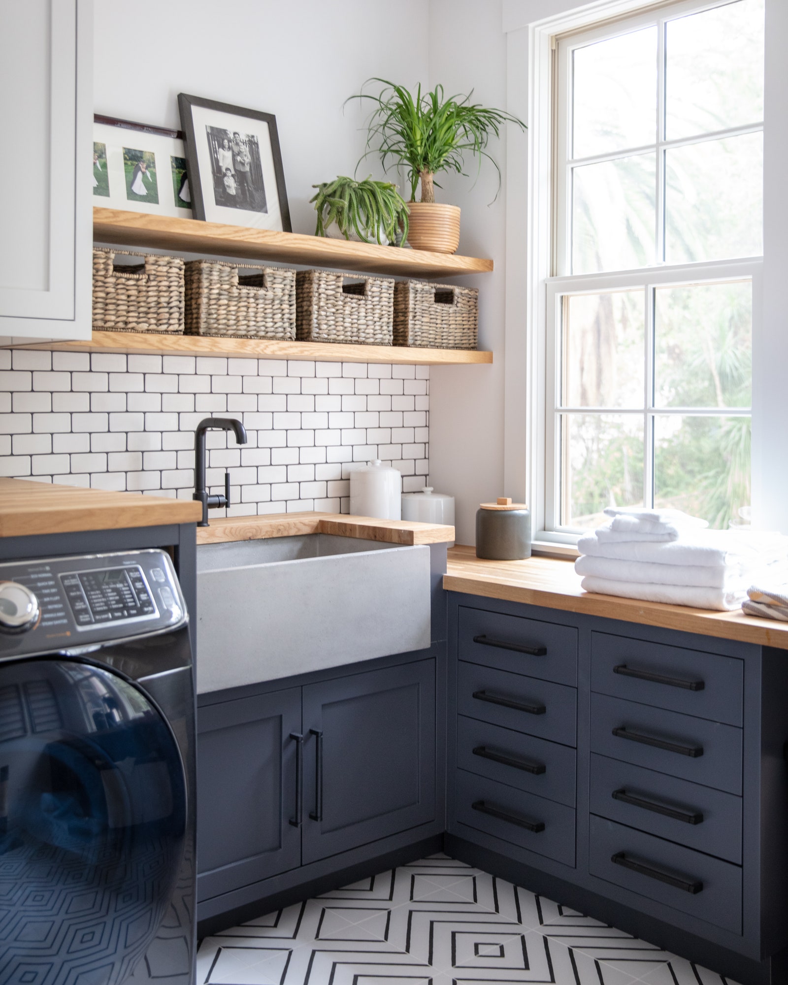 DIY floating shelves for additional storage space in a tiny laundry room.